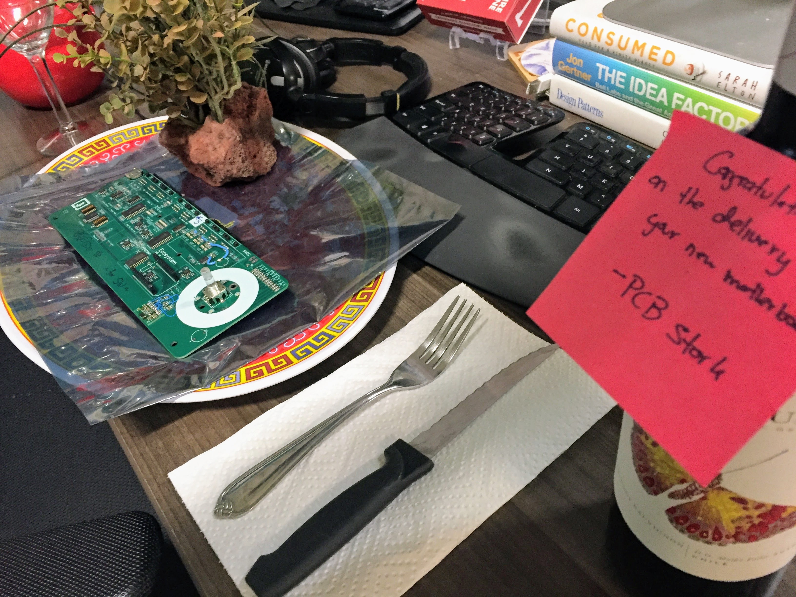The first motherboard from the hardware team, delivered on a platter with a bottle of wine. If you're going to work yourself to the bone, you have to at least have fun with it.