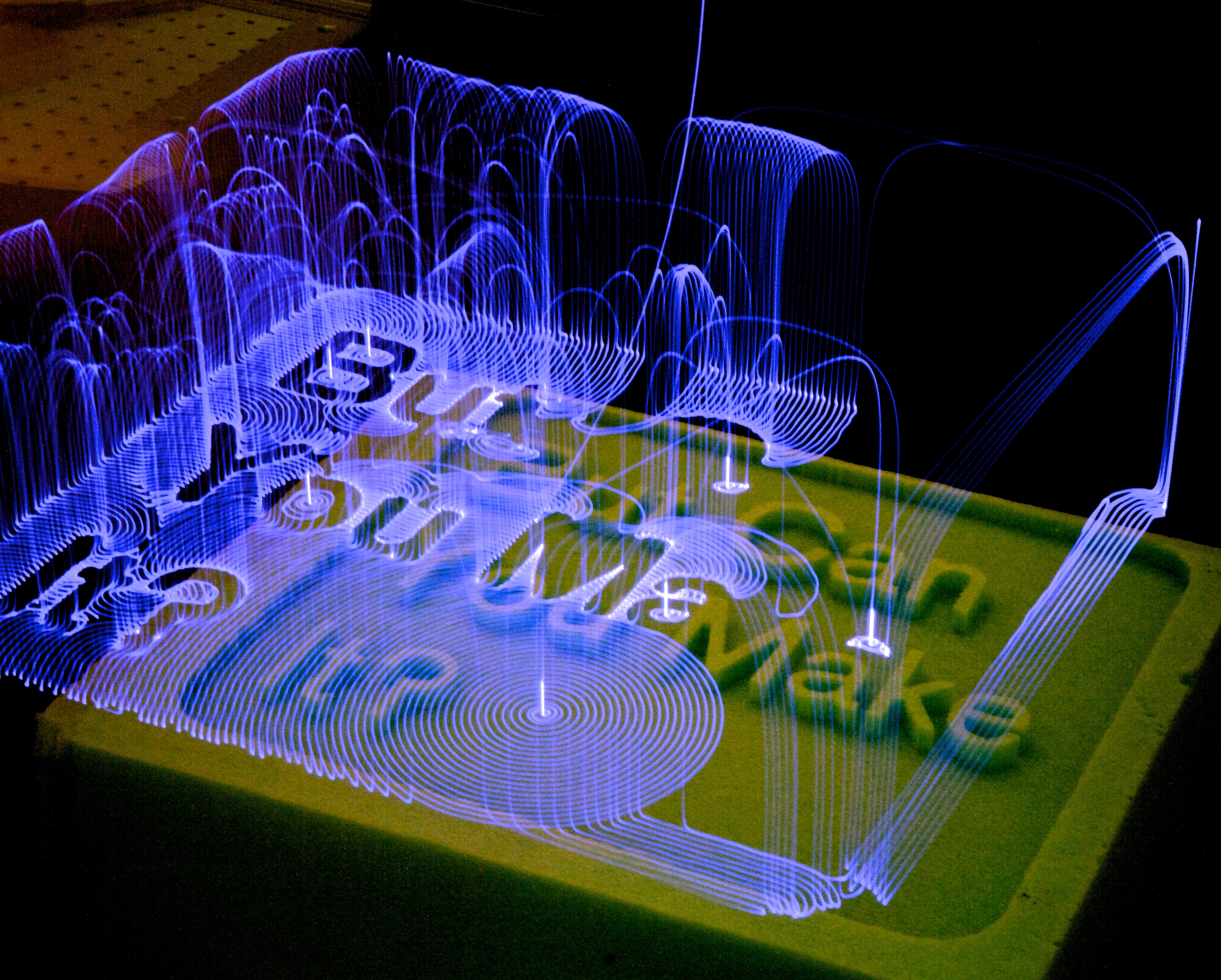 Light art made with long exposure photography and the robotic arm. I love looking closely at the paths the arm makes, its complex planning laid out so neatly